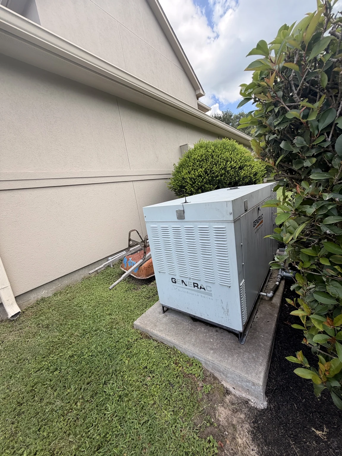Liquid-cooled standby generator beside a residence